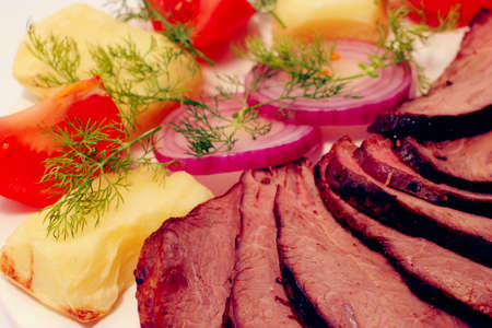 grilled beef meat steak with fried potatoes and tomatoes on white plate isoalted over white