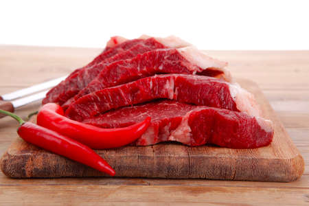 fresh raw beef meat steak's on wooden cut board over wooden table with dill and stainless steel...