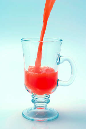 orange juice flow to glassの写真素材