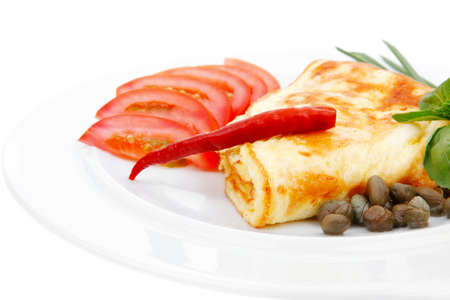 omelette with tomatoes and pepper served on white plate isolated on white backgroundの写真素材