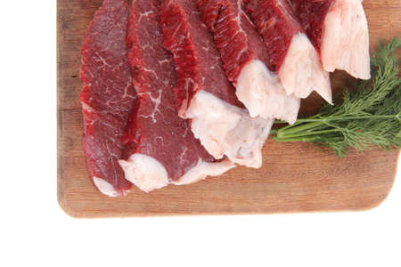fresh raw beef meat steak slices on wooden cut board isolated over white background