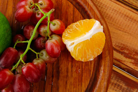 fresh raw red grape on wooden tableの写真素材