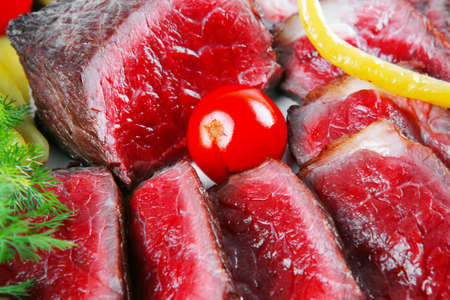 grilled beef meat entrecote on white plates with peppers and tomato isolated on white 