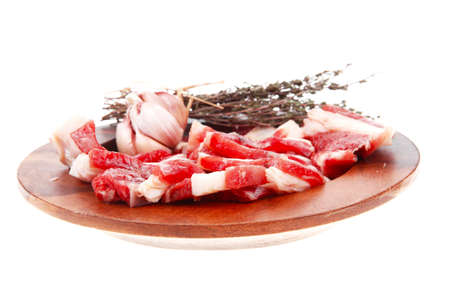 raw ribs with thyme and garlic on wooden isolated over white backgroundの写真素材
