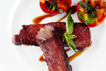 fresh red beef meat steak barbecue garnished vegetable salad and basil  in half of pepper bell on...