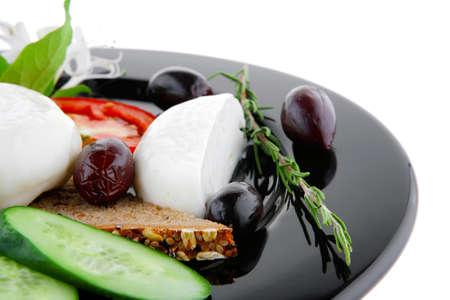 fresh white mozzarella cheese with vegetables on blackの写真素材