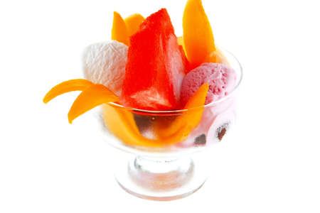 small transparent glass cup with ice cream and tropical fruits isolated on white 