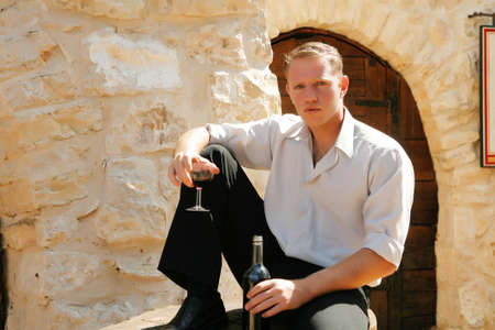 young happy white caucasion man taste and enjoy red wine outdoor in in countryside
