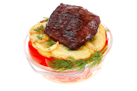 fresh roast beef meat chunk in transparent bowl over baked potatoes and tomatoves served with fill isolated over white backgroundの写真素材