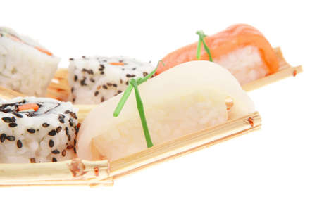 Japanese Cuisine - Maki Roll with Deep Fried Vegetables inside with Sashimi made of Smoked Salmon and Eel. on wooden boats . isolated over white backgroundの写真素材