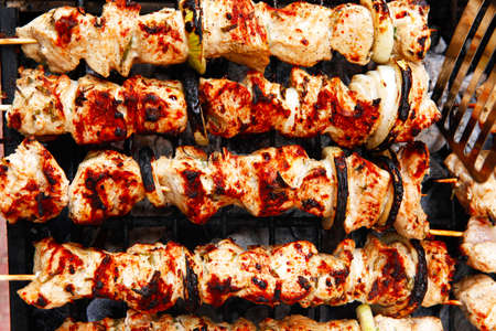 healthy shish kebab - grilled bbq chicken turkish meat on skewers over charcoal brazier outdoorの写真素材