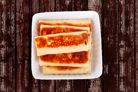 russian food - pancake with various fillings served over old style wooden tableの写真素材