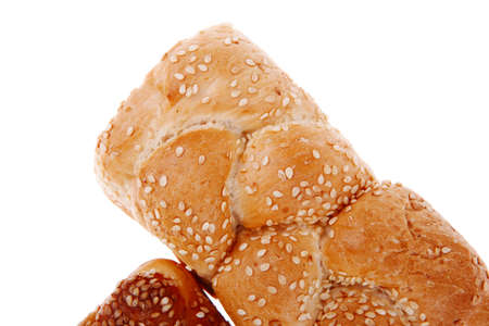 hot bun of light wheat bread topped by sesame seeds isolated over white background