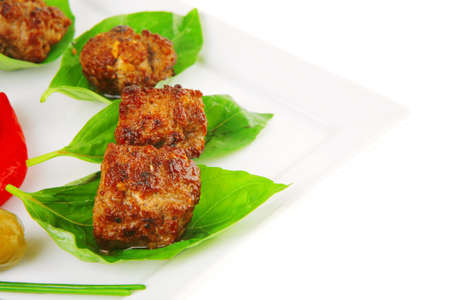grilled french cutlets served on basil leafsの写真素材