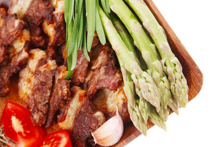 beef meat grilled ribs with asparagus and tomatoes isolated over white backgroundの写真素材