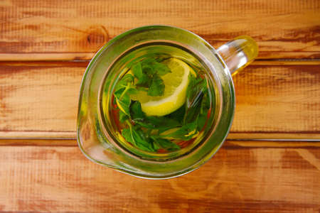 hot tea with mint on wooden tableの写真素材
