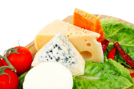 delicatessen cheeses on wooden board with vegetables olive oil and bread isolated over white...