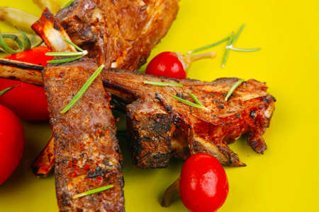 meat savory: roast ribs on green plate with peppers and chivesの写真素材