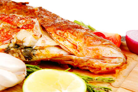 savory on wood: two fried fish served with tomatoes and lemon