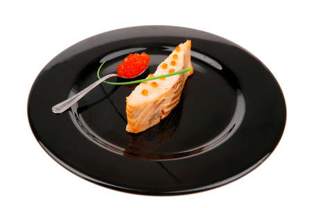 healthy fish cuisine : roasted pink salmon fillet with  onion pen , and red caviar in spoon on black dish isolated over white backgroundの写真素材