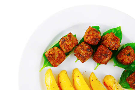 served meatballs on basil leaf with gold potatoesの写真素材