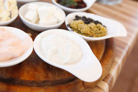 set of tapas on wooden table outside cafe