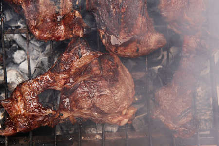 fresh hot bbq grill red beef meat steak ready on grid over charcoal with marksの写真素材