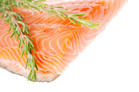 piece of big salmon fillet with rosemary over whiteの写真素材