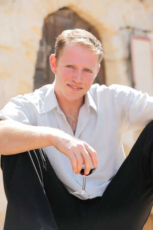 young happy white Caucasian man enjoy red wine in outdoor