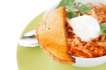 red tomato soup with toasts on green plate
