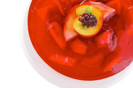 image of cold red jelly cake with fruits inside and blackberryの写真素材