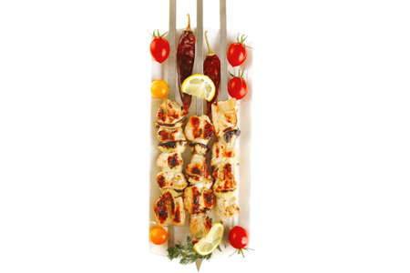 fresh grilled shish kebab on white platterの写真素材