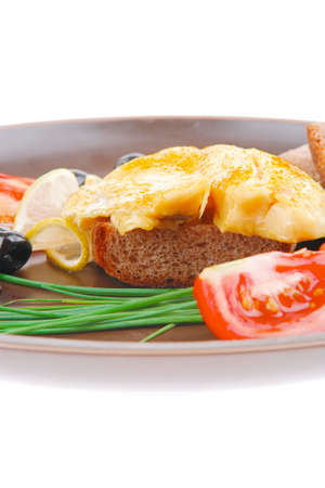 served roast golden fish fillet with tomatoes, rye bread and olivesの写真素材