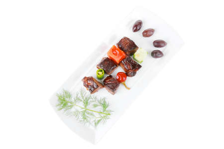 european food: roast beef meat goulash over white plate isolated on white background with tomatoes and dillの写真素材