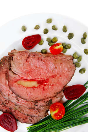 roasted meat served on white dish with capersの写真素材