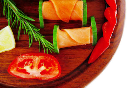 image of smoked salmon rolls on wooden plateの写真素材