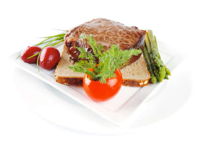 meat with spices and eggplant on white plateの写真素材