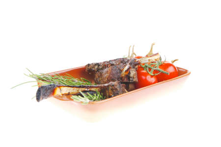 grilled ribs with fresh raw cherry tomatoes and chivesの写真素材