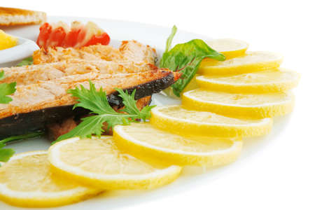 grilled salmon and lemon on white plateの写真素材