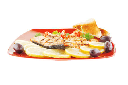 grilled salmon and lemon on red plateの写真素材