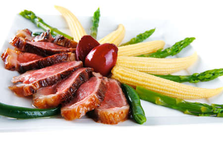 beef meat on white plate with beans and cornsの写真素材