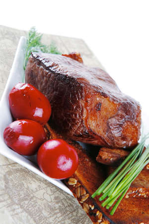 grilled meat served with vegetables and breadの写真素材