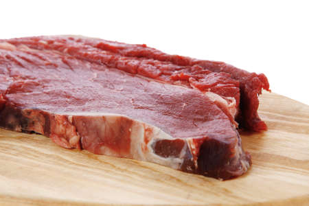 fresh raw beef steak fillet on wood isolated over white background