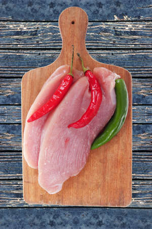 fresh raw turkey meat steak fillet over blue wooden tableの写真素材