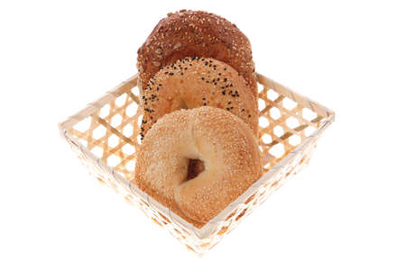 three different bagels in basket isolated over white backgroundの写真素材