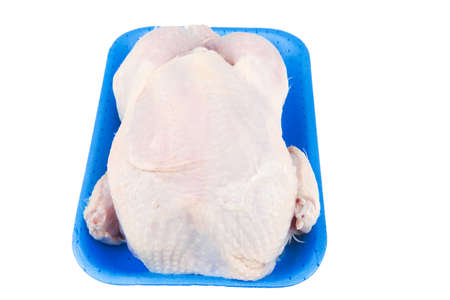 whole raw chicken on blue tray isolated on white backgroundの写真素材