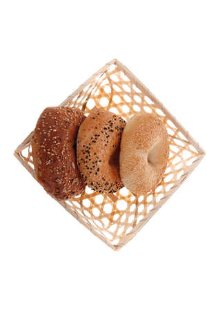 three different bagels in basket isolated over white backgroundの写真素材