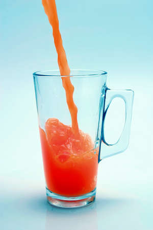 orange juice flow to glassの写真素材