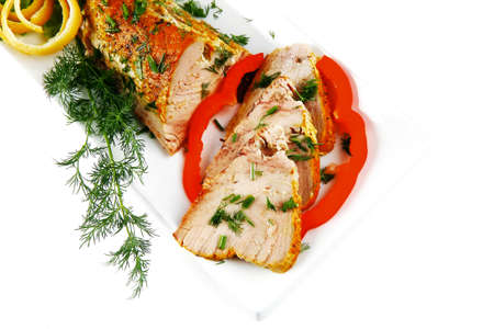 healthy dinner: grilled sea tuna fish with lemon and vegetables on white china plate isolated over white backgroundの写真素材