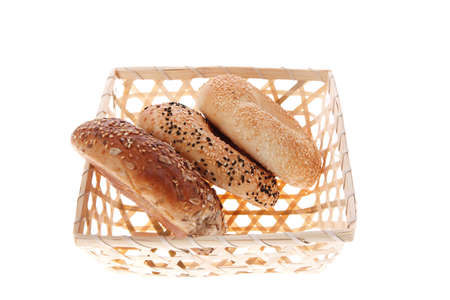 three different bagels in basket isolated over white backgroundの写真素材